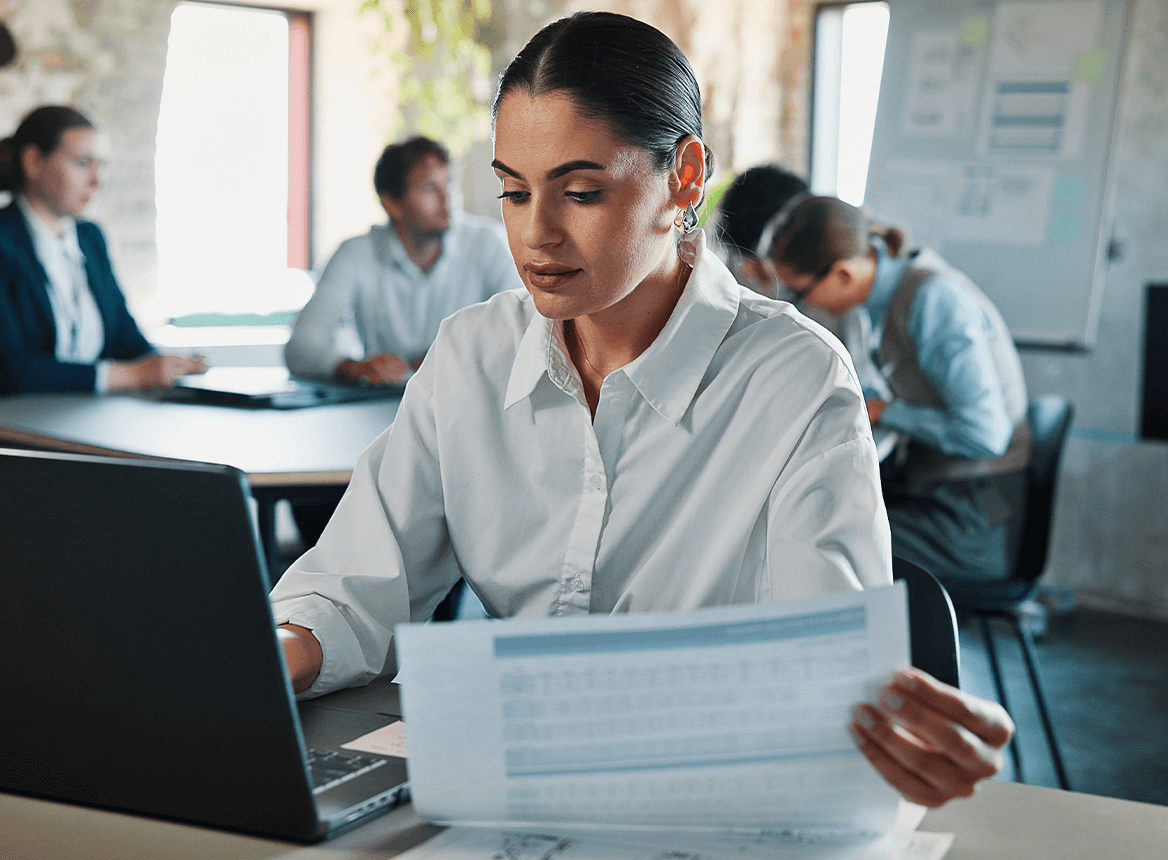 Business professional working on laptop meeting room