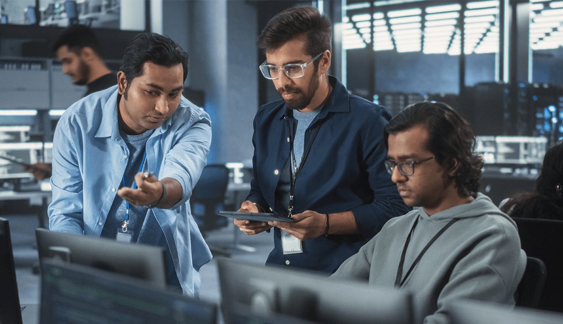 Team looking at computer in SOC